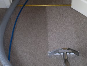 Extraction cleaning the carpet with a floor wand