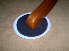 Table leg with furniture slider underneath it