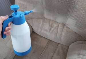 Using a pump sprayer to apply pre conditioning treatment to an armchair 