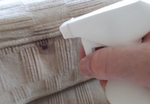 Treating spot stains on an upholstered sofa